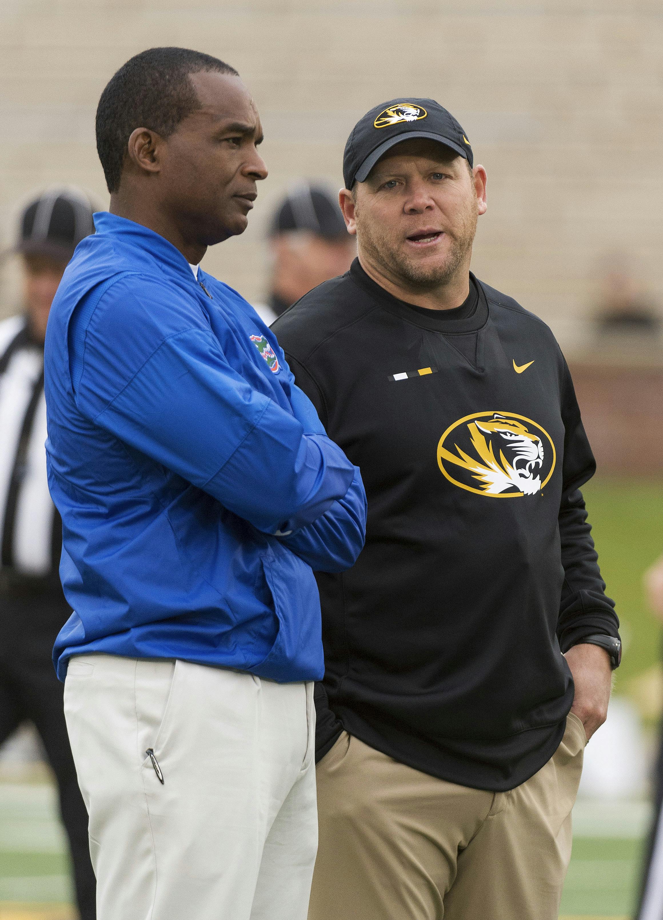 Missouri head coach Barry Odom, right, talks with Florida head coach Randy Shannon, left, before the start of an NCAA college football game Saturday, Nov. 4, 2017, in Columbia, Mo. (AP Photo/L.G. Patterson)