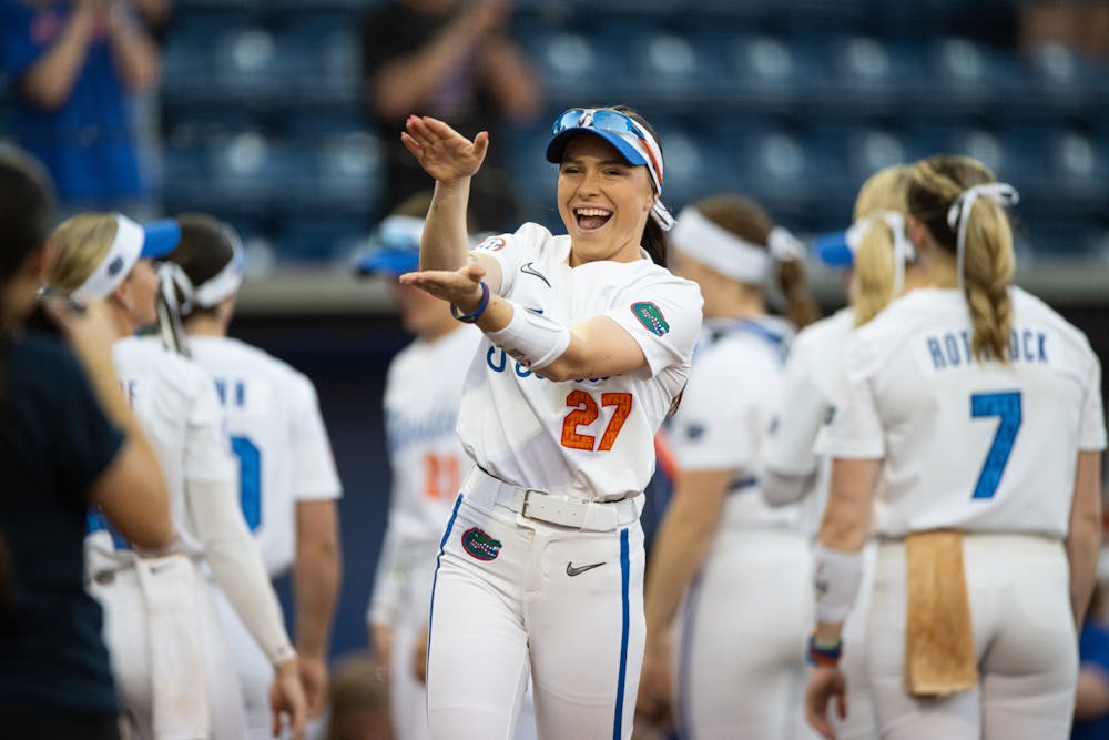 Florida Gators outfielder Kendra Falby (27) does the gator chomp as she walks out of the dugout before a game against North Florida on Feb. 6, 2025.