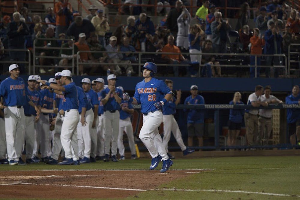 <p>UF catcher Mark Kolozsvary rounds the bases after hitting a home run in Florida's 2-0 win against Miami on Feb. 25, 2017, at McKethan Stadium.</p>