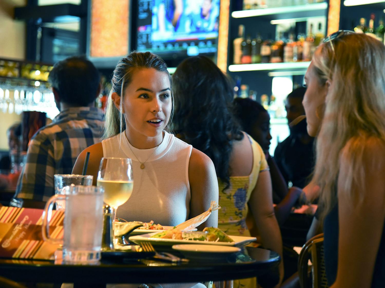 Jordan Kovacs, a 21-year-old UF health science student eats dinner with Sophie Franklin, a 21-year-old UF biology student, at the Cheesecake Factory grand opening Tuesday night. About 150 people came to the opening, some waiting in line for up to two and a half hours to be seated. “I’ve been going back to the one at home for 10 years,” Kovacs said about the restaurant chain. “Of course I’m here for the opening night.”