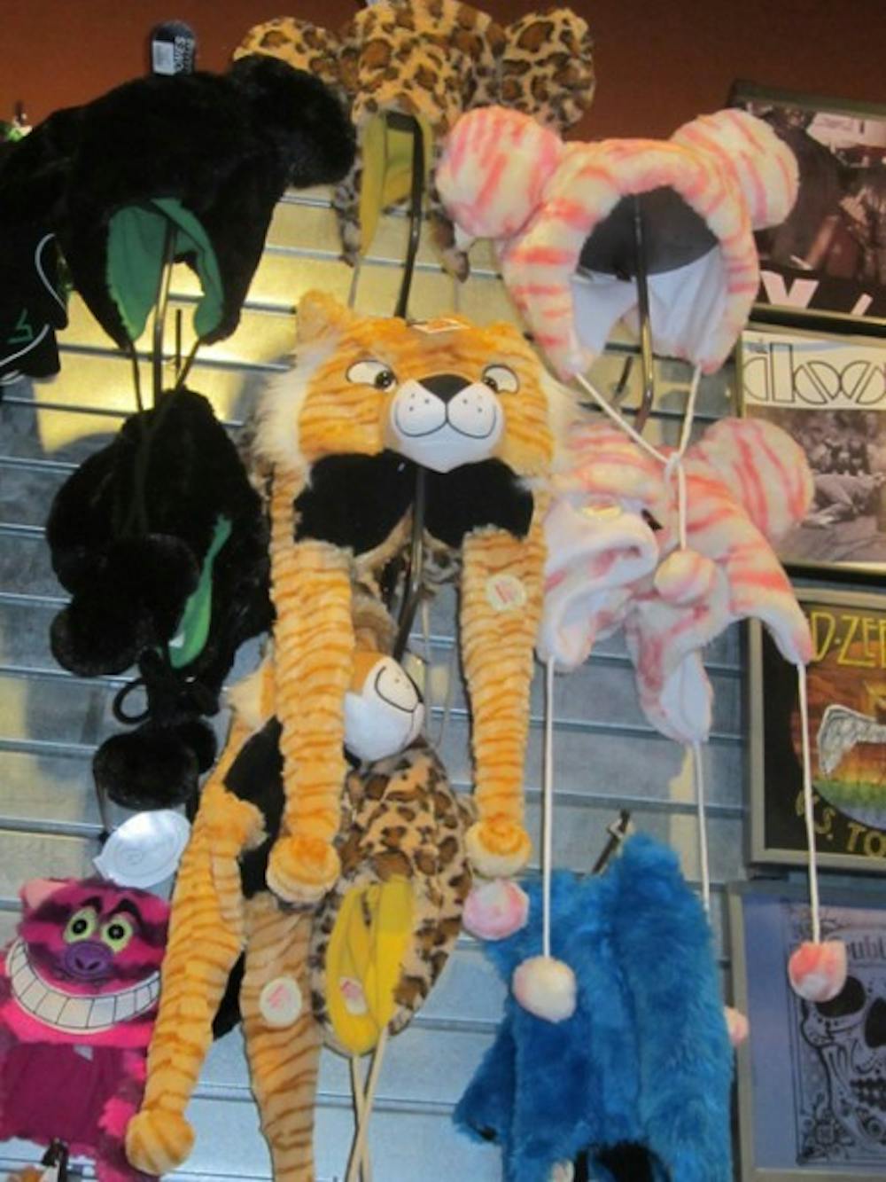 <p>Critter and character hats line the walls of Spencer's in the Oaks Mall.</p>