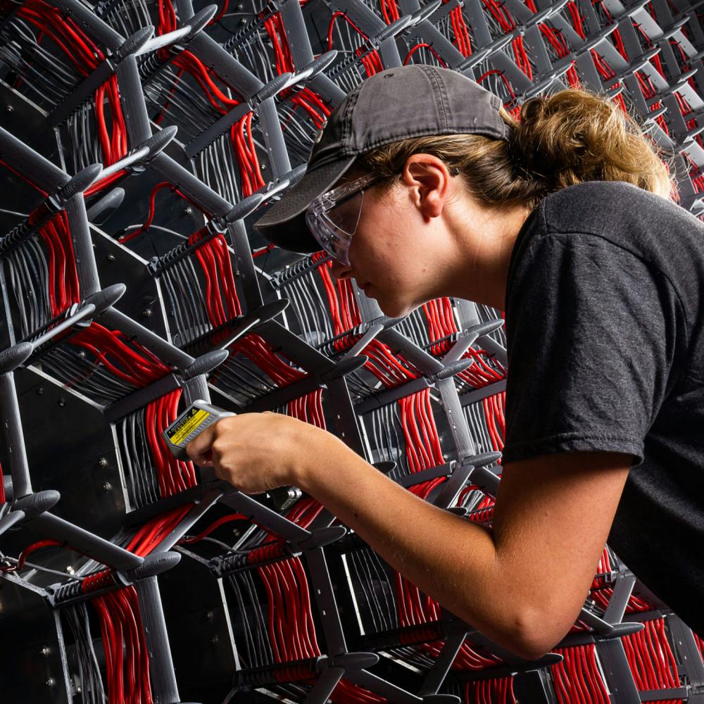A student enrolled in the National Science Foundation's Research Experience for Undergraduates program works on one of the fans