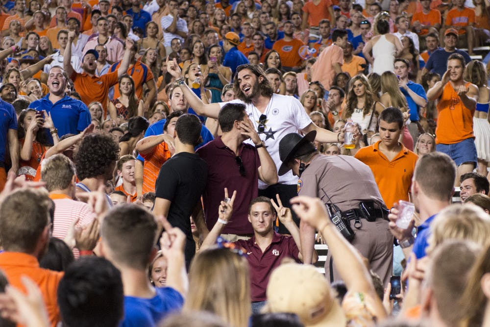 A man wearing a Florida State University shirt reacts prior to being escorted out by police in Ben Hill Griffin Stadium during halftime at the Kentucky game Saturday night.