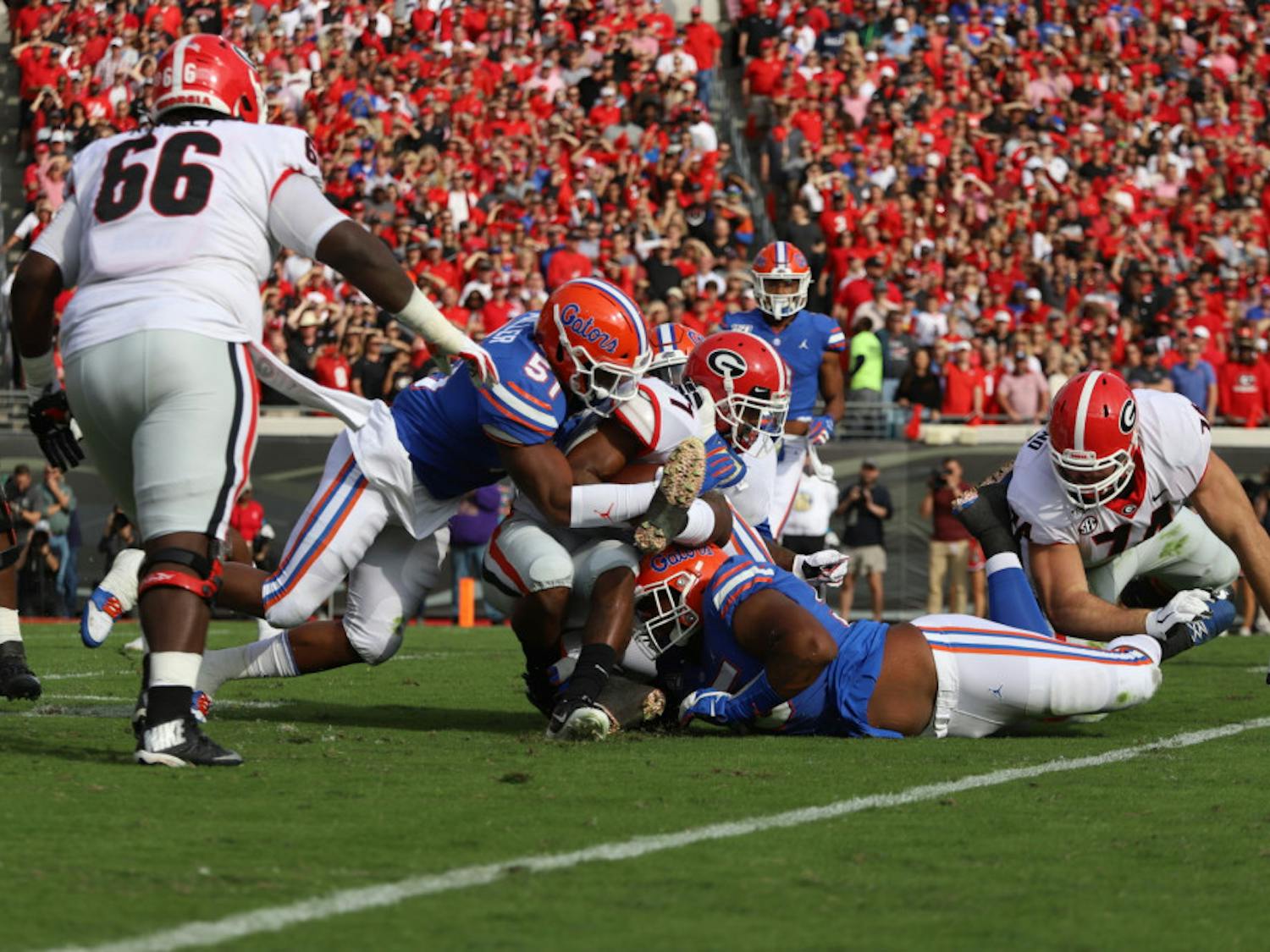 Linebacker Ventrell Miller and his teammates tackle a Georgia ball carrier Nov. 7, 2020. Miller returns to UF this season after tearing his bicep last year.