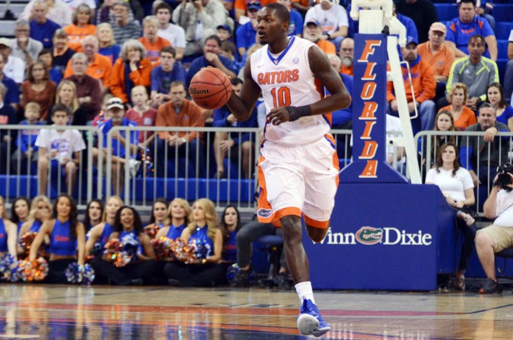 <p>Dorian Finney-Smith dribbles the ball during Florida's 79-34 win against Jacksonville.</p>