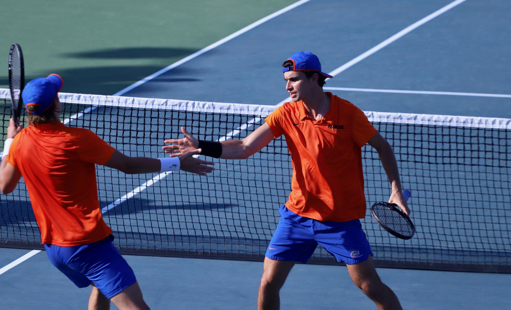 Freshman Nate Bonetto (left) and senior Duarte Vale celebrate a score. The Florida men’s tennis team rolled the Crimson Tide Friday night, 5-2