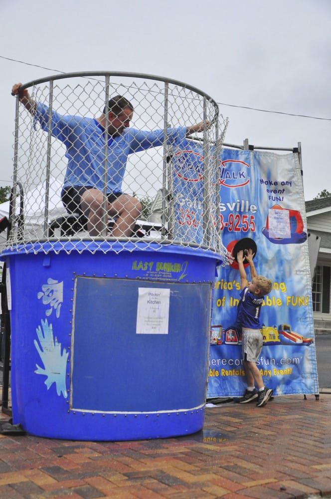 Avery Hill, 4, dunks Gainesville City Commissioner Todd Chase at Cymplify's First Food Truck Rally on Oct. 4, 2015. The event helped raise money for a kitchen at GRACE Marketplace, a non-profit local homeless center.