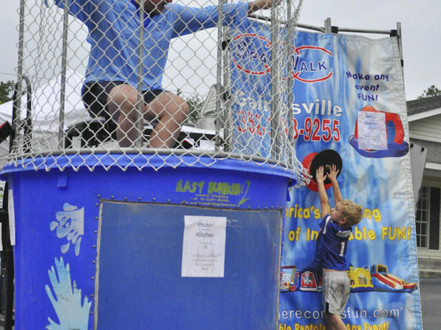 Avery Hill, 4, dunks Gainesville City Commissioner Todd Chase at Cymplify's First Food Truck Rally on Oct. 4, 2015. The event helped raise money for a kitchen at GRACE Marketplace, a non-profit local homeless center.
