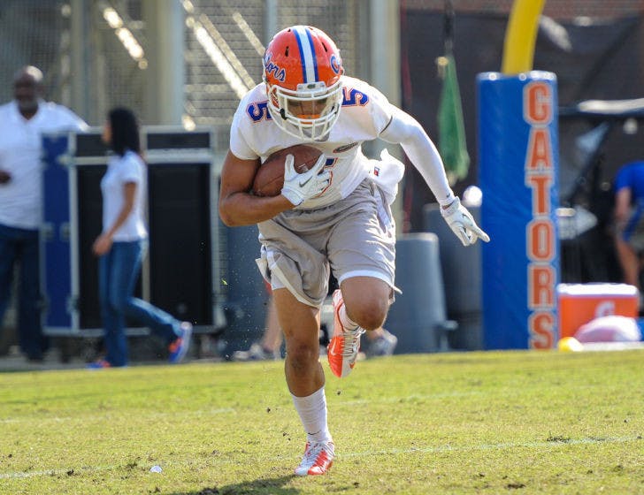 Jalen Tabor carries the ball during Florida’s second open practice on March 21 at Sanders Practice Fields.