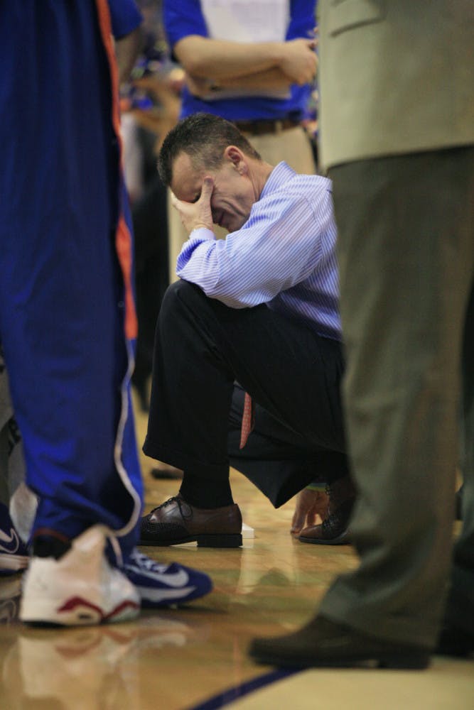 Coach Billy Donovan rubs his eyes during a timeout in Florida’s 71-54 win against Arkansas on Saturday in the O’Connell Center.