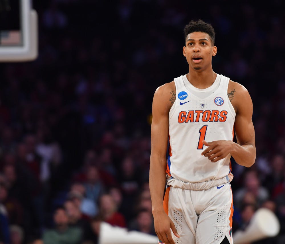 <p>Devin Robinson stands on the court during Florida's 77-70 loss against South Carolina in the Elite Eight of the NCAA Tournament on March 26.</p>