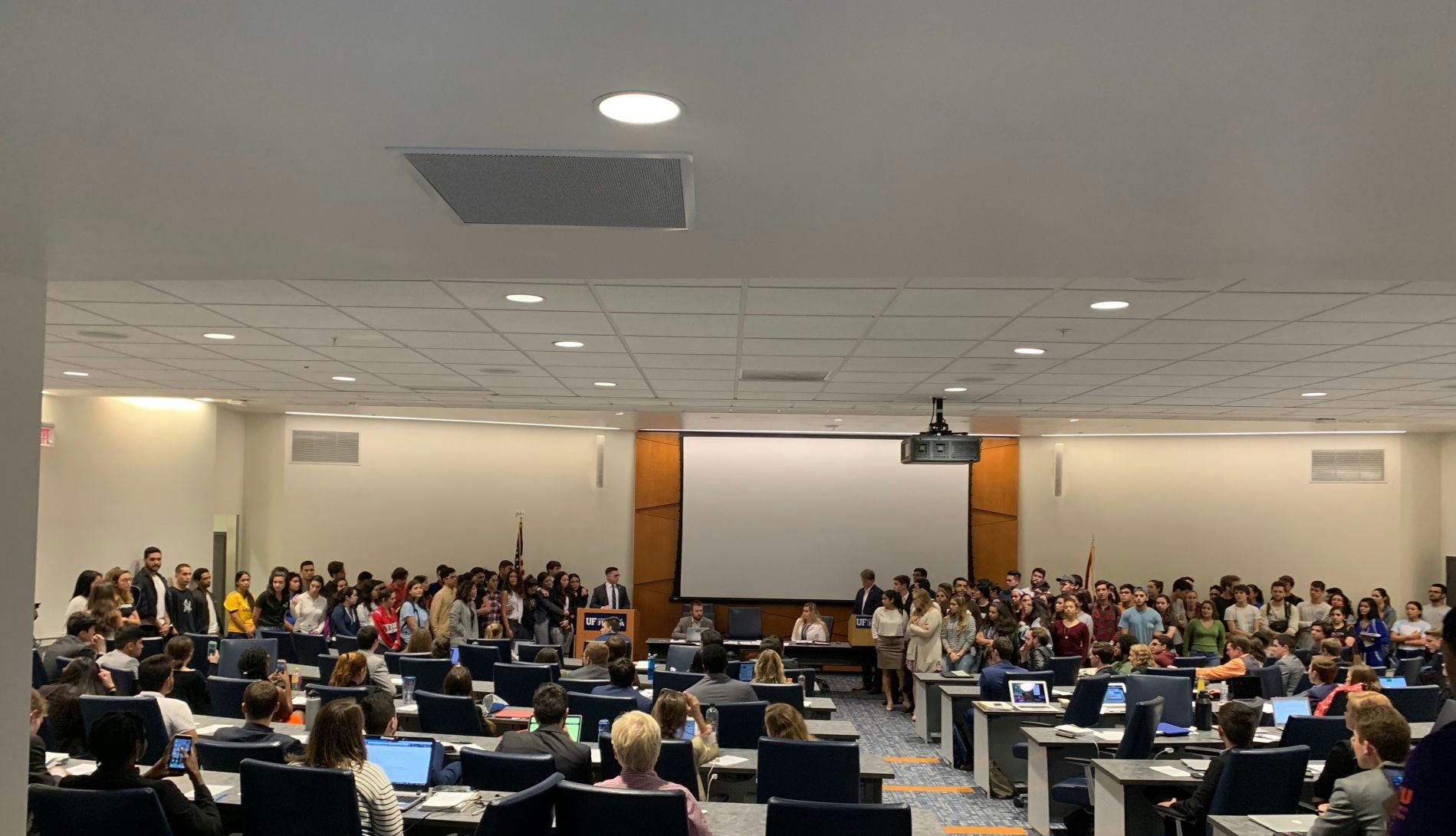 Students from the Hispanic Student Association surround Student Body Vice President David Enriquez as he expresses his support for a resolution affirming Juan Guaidó as the interim president of Venezuela.