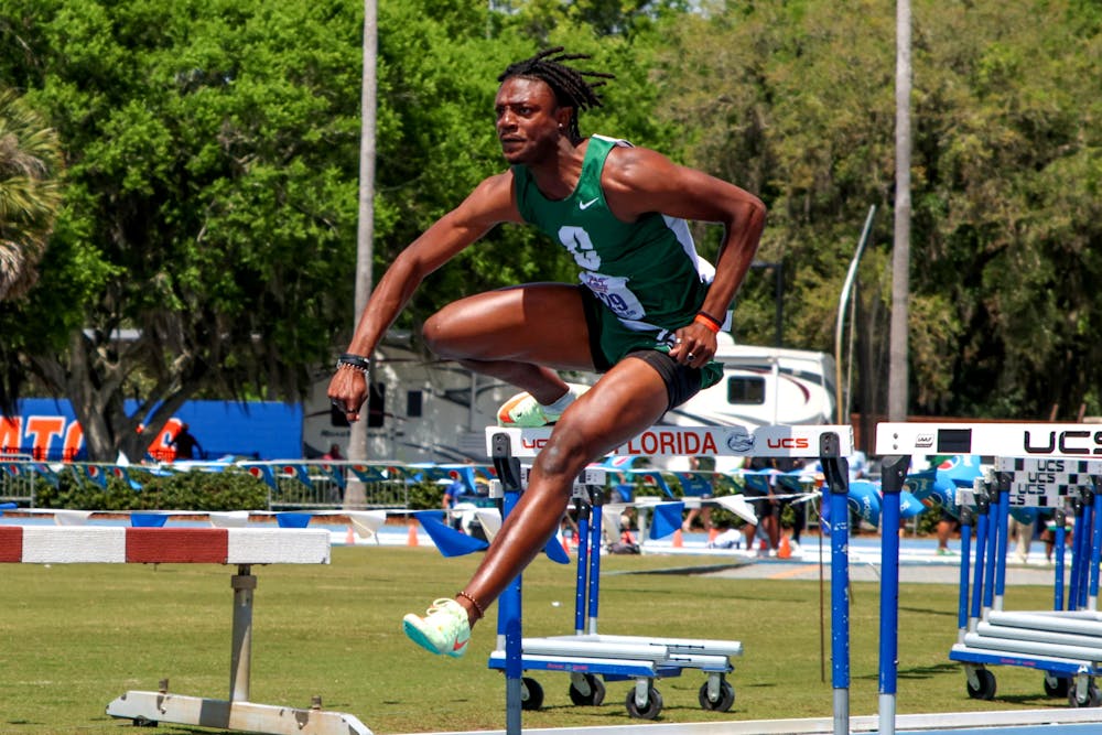 <p>UNC Charlotte track and field athlete Sam Thompson clears a hurdle wearing a green uniform similar to his high school attire during the Pepsi Florida Relays Friday, March 31, 2023. Thompson was a student at UF before he transferred and joined UNC Charlotte&#x27;s team.</p>