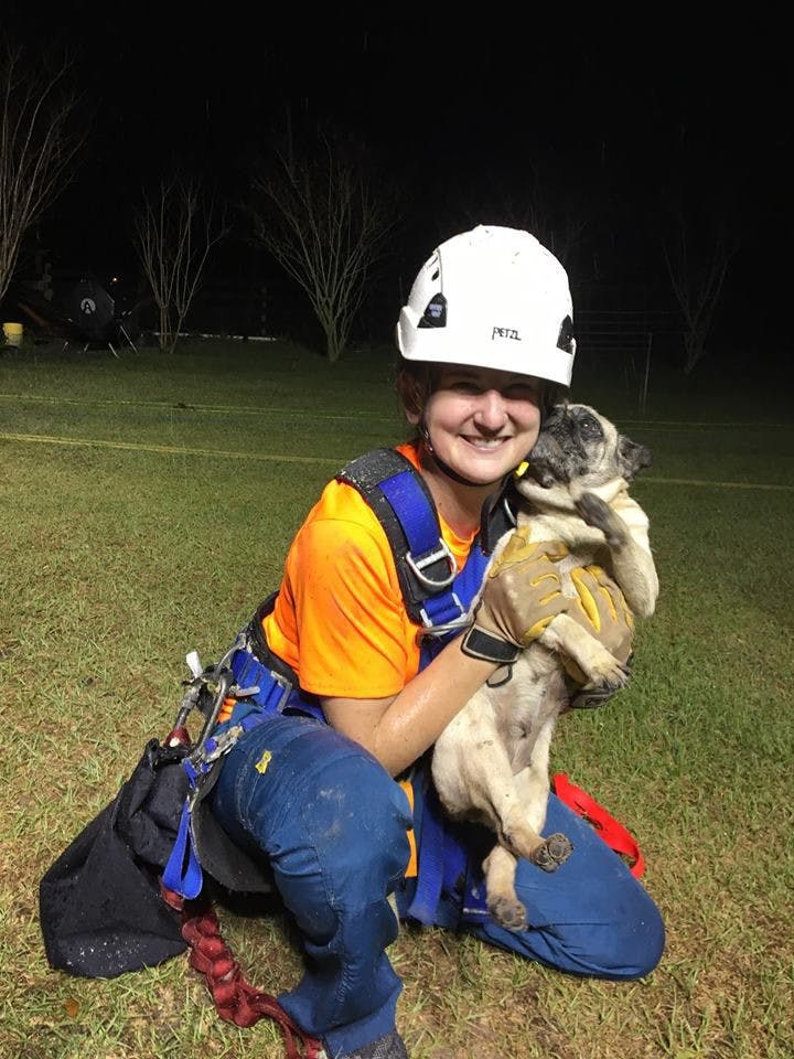 Jenny Groover, a team member with UF Veterinary Emergency Treatment Service, holds Cookie after rescuing the dog from a 30-foot sinkhole.
&nbsp;