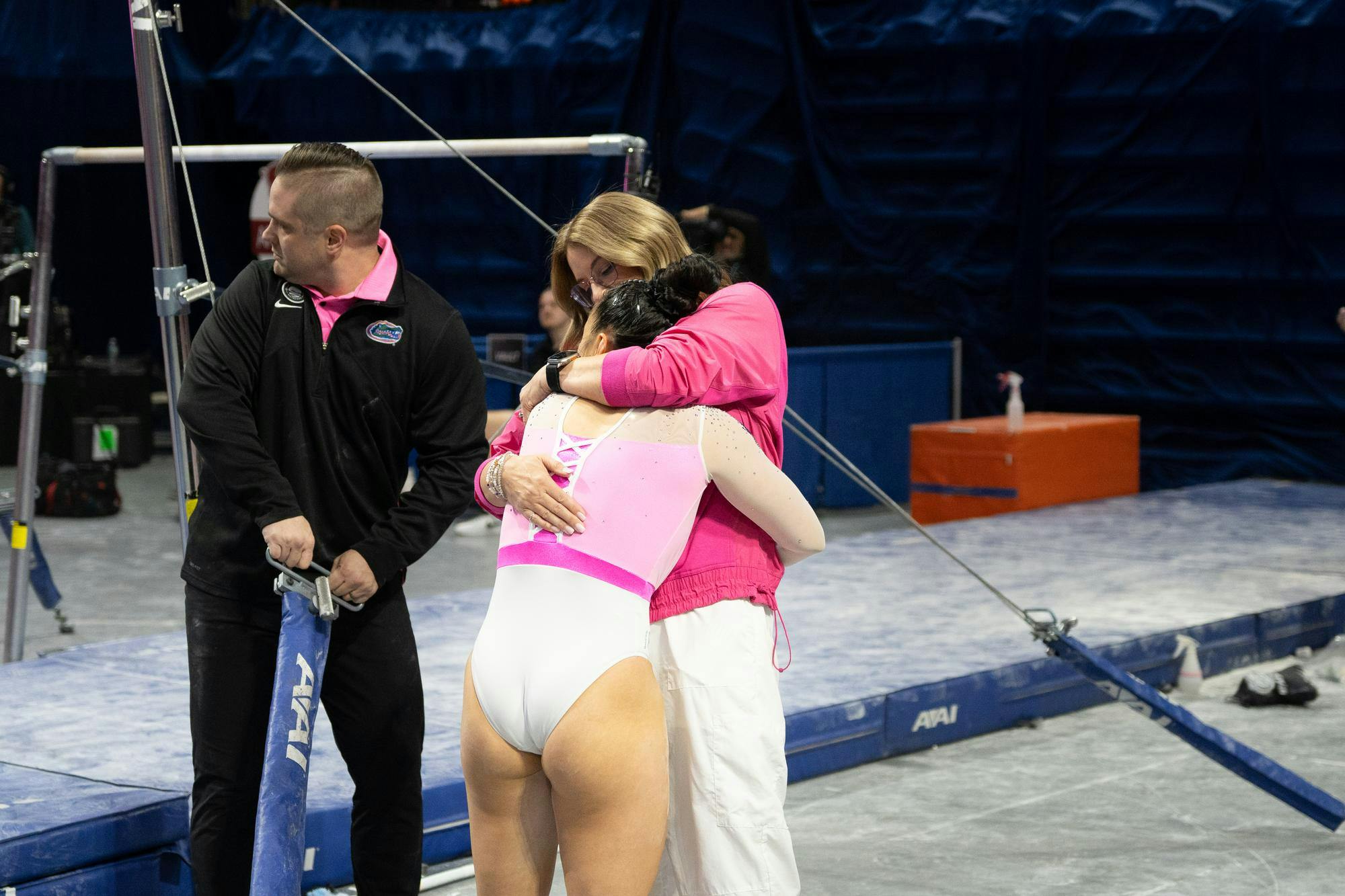 Florida gymnastics head coach Jenny Rowland hugs senior gymnast Ellie Lazzari after her performance on the uneven bars against Arkansas on Friday, Feb. 9, 2024.