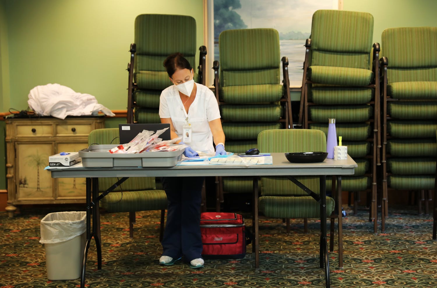 Tiffany Bach, the manager of the CITRUS Study, arranges files after collecting blood samples on Wednesday, June 9, 2021.
