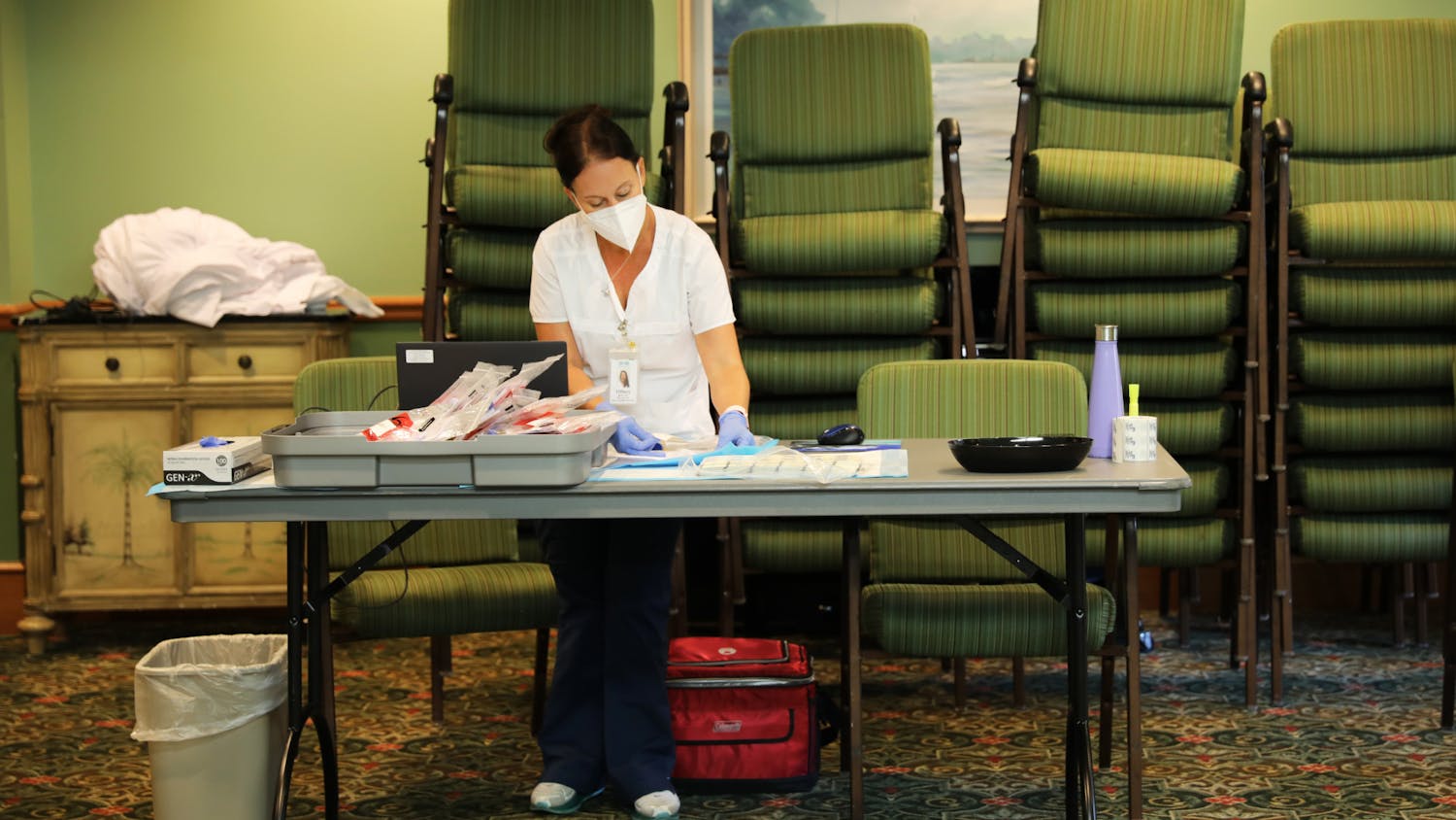 Tiffany Bach, the manager of the CITRUS Study, arranges files after collecting blood samples on Wednesday, June 9, 2021.
