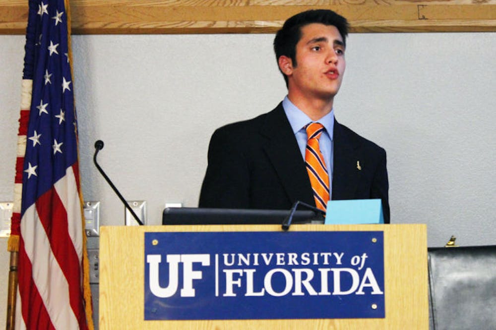 <p>Student Government Budget and Appropriations Committee Chairman Joseph Michaels presents the 2013-2014 academic and student organization budgets to the Student Senate on Tuesday night.</p>