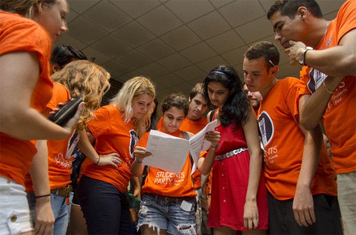 With other Students Party members looking on, President Daniella Saetta frowns at the results of Wednesday’s Student Government election. Students Party won two Senate seats: District E and Murphree Area.