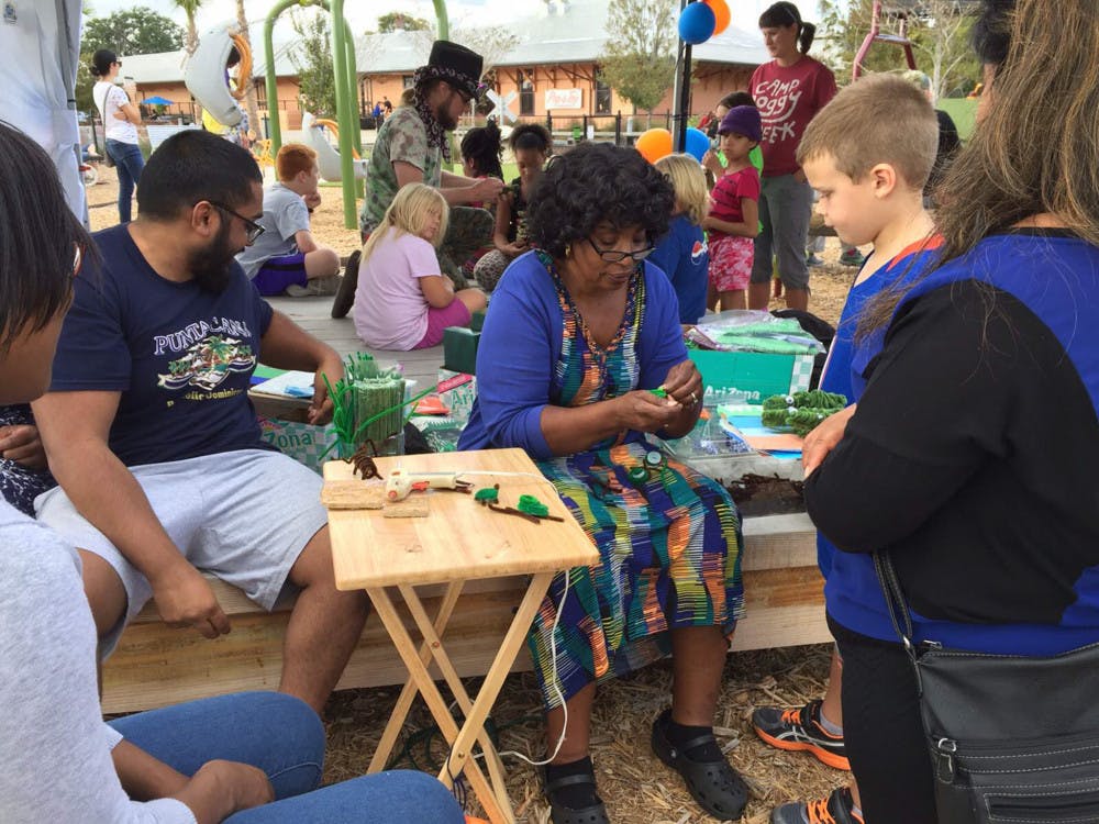 Surrounded by her family, Joy Graham Miller shows David, 7, how to make a toy turtle out of pipe cleaners and bottle caps on his birthday on Sunday.