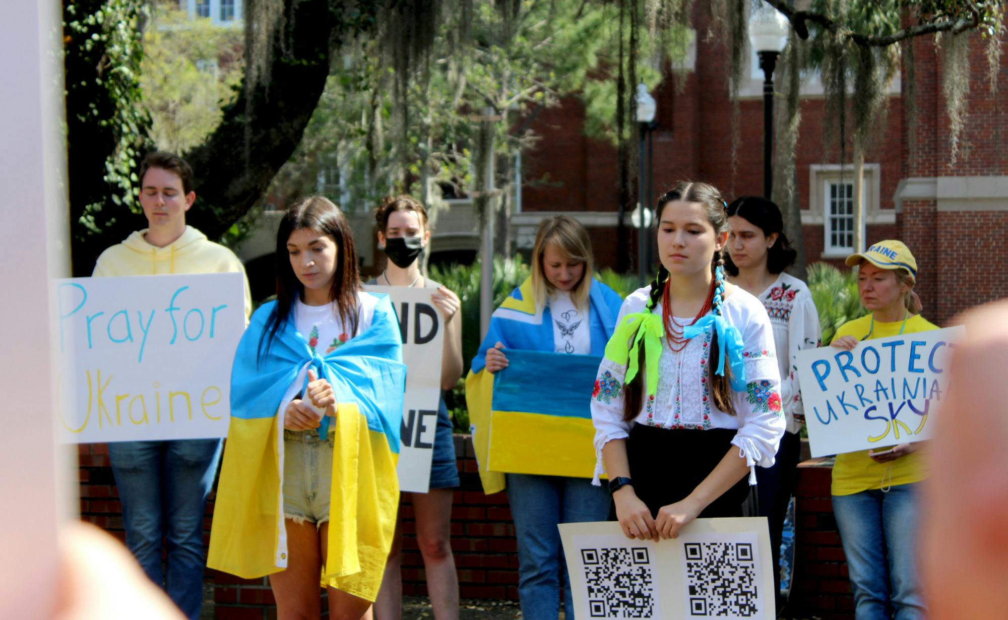Roksolana Myktiuk, 25, a non-degree seeking UF women’s studies exchange student (left) and Sasha Nelson, 19, UF microbiology sophomore lead a group of about 30 in a minute of silence for the Ukrainian lives lost in their ongoing war with Russia on Thursday, March 3.