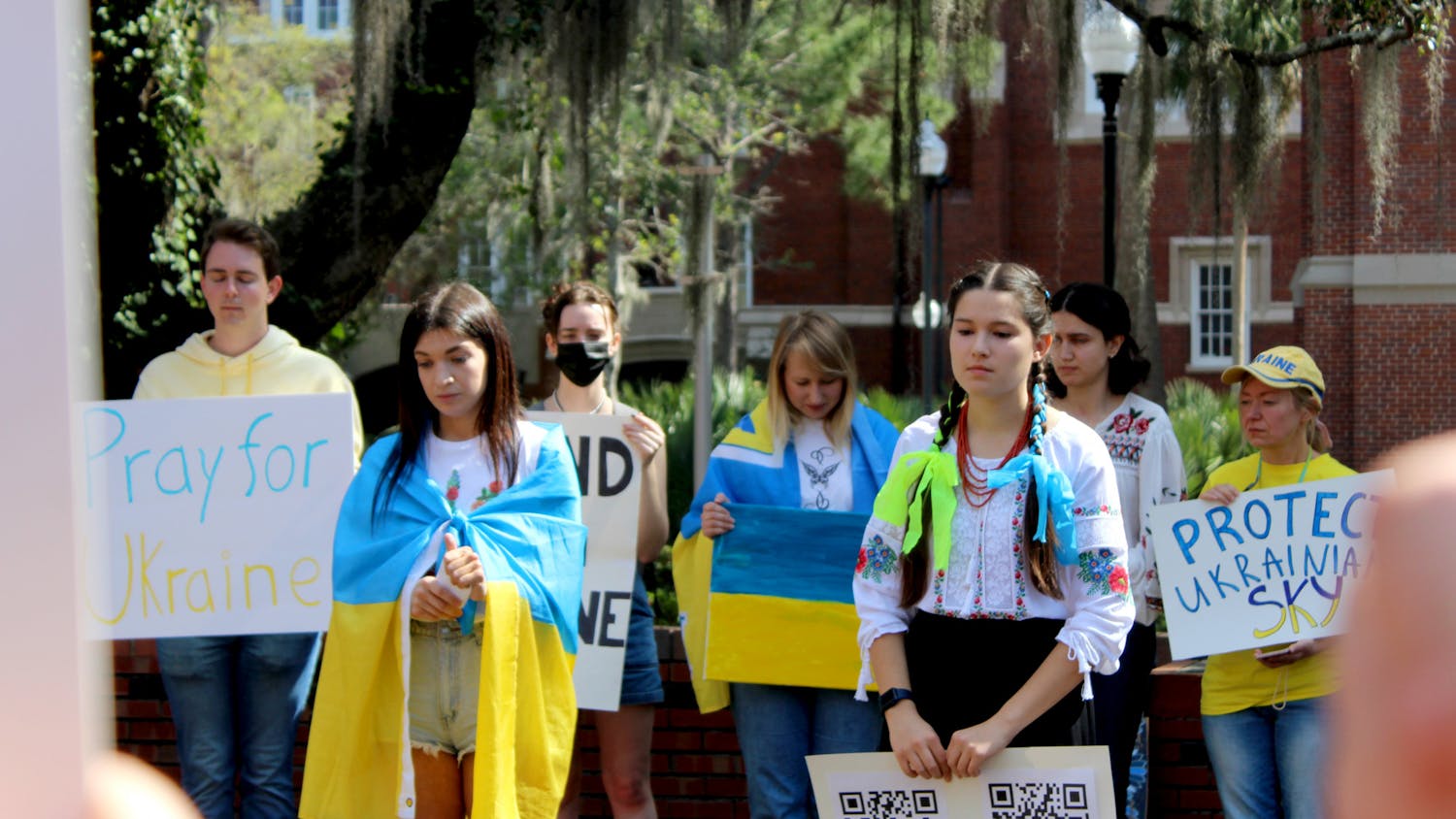 Roksolana Myktiuk, 25, a non-degree seeking UF women’s studies exchange student (left) and Sasha Nelson, 19, UF microbiology sophomore lead a group of about 30 in a minute of silence for the Ukrainian lives lost in their ongoing war with Russia on Thursday, March 3.