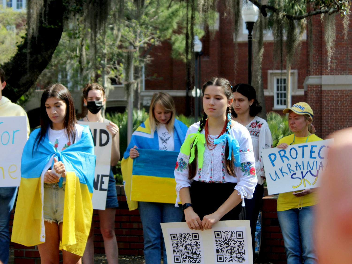 Roksolana Myktiuk, 25, a non-degree seeking UF women’s studies exchange student (left) and Sasha Nelson, 19, UF microbiology sophomore lead a group of about 30 in a minute of silence for the Ukrainian lives lost in their ongoing war with Russia on Thursday, March 3.