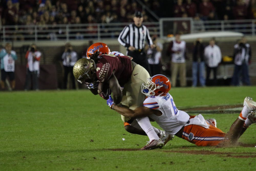<p>Quincy Wilson, right, tackles Dalvin Cook during Florida's loss to Florida State on Nov. 26, 2016, in Tallahassee.</p>