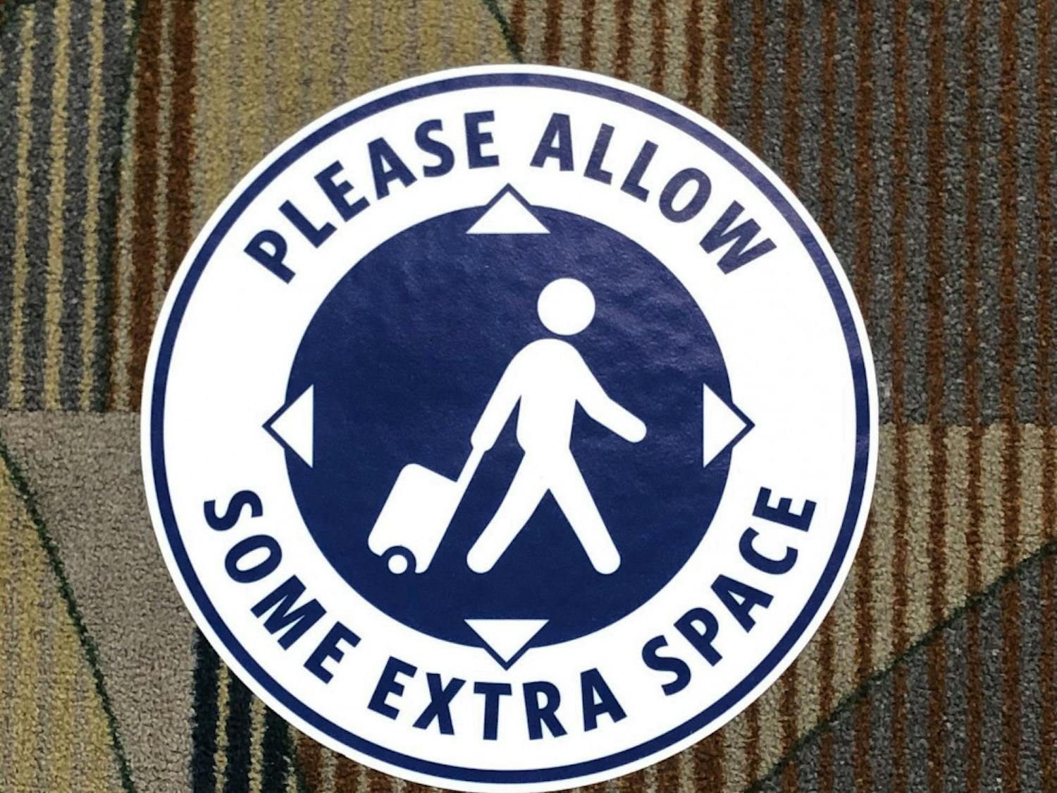A stick on the floor of the Gainesville Regional Airport promoting social distancing.