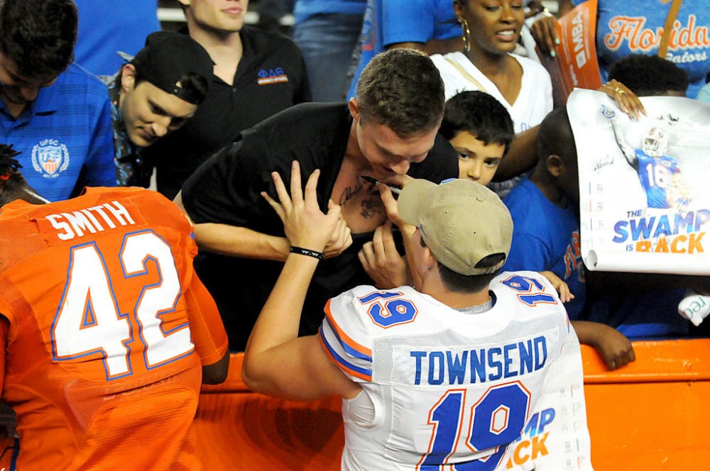 Johnny Townsend, the Gators redshirt junior punter, signs Thierry Pitot's chest after the 2016 Orange &amp; Blue Debut in Ben Hill Griffin Stadium on Friday night. The 20-year-old tourism and hospitality management sophomore was part of a reported crowd of 46,000.