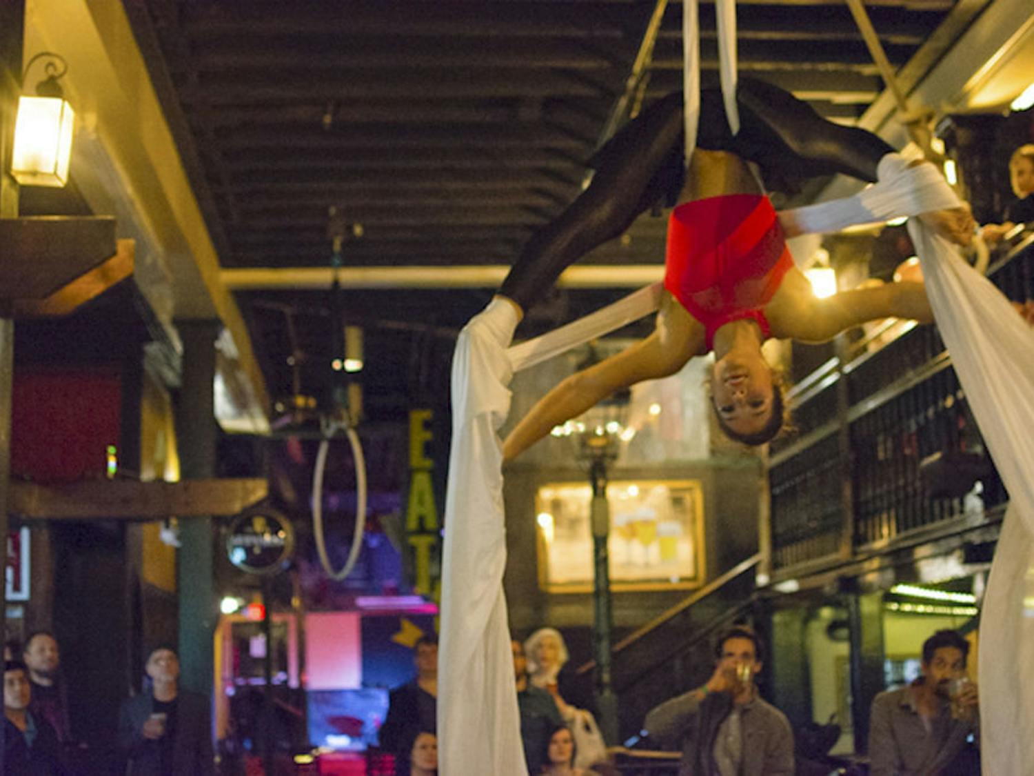 Slipping through silk, Kelly Ulmer performs an aerial dance with three other aerial artists at the Electro Aerial show. She has been aerial dancing for two years and silks her favorite.