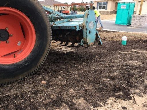 Researchers place compost on developing land plots. The team's first study is taking place at Ocala's On Top of the World retirement community.