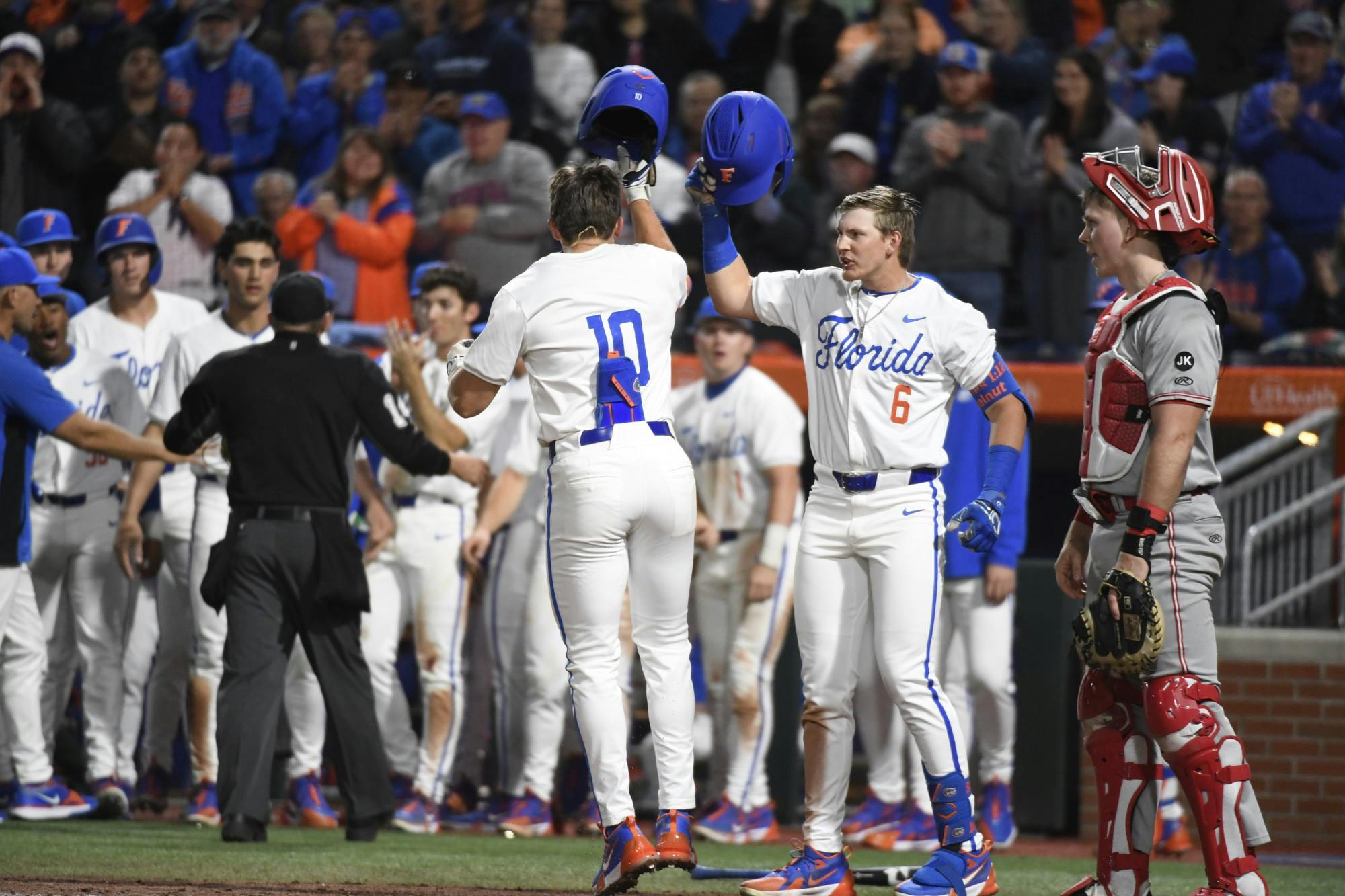 Gators baseball shortstop and left fielder Tyler Shelnut celebrate Shelton's home run at home plate in Florida's loss to St. John's on Friday, February 16, 2024. 