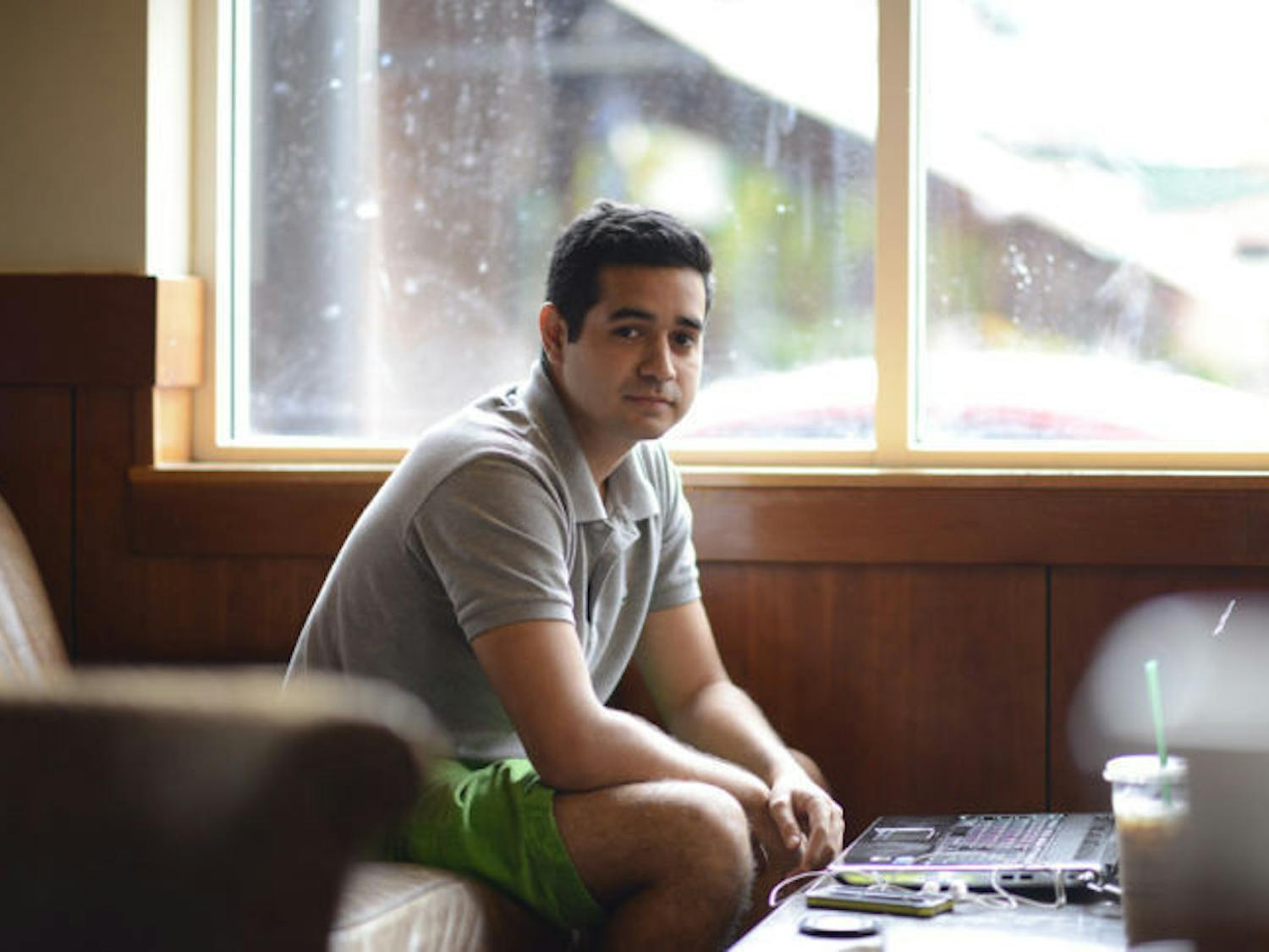 Entrepreneur and recent UF graduate Patrick Arenson sits in the downtown Starbucks on Wednesday afternoon. The 23-year-old has written two books and is raising money on Kickstarter to publish his third.