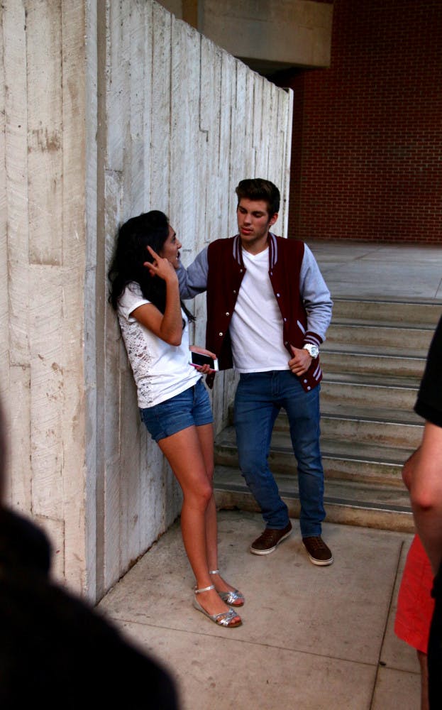 Trip, played by Ryan Golden, 19, hits on his ex-girlfriend Ashley, played by Marissa Secades, 19, at a party. The characters moved the audience to other spots in the Newins-Zeigler Hall Breezeway throughout the night as they followed the story of Ashley's sexual assault and the reactions from her friends and family.