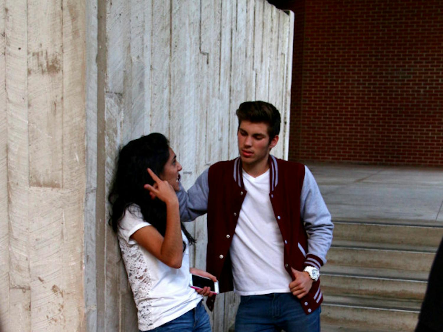 Trip, played by Ryan Golden, 19, hits on his ex-girlfriend Ashley, played by Marissa Secades, 19, at a party. The characters moved the audience to other spots in the Newins-Zeigler Hall Breezeway throughout the night as they followed the story of Ashley's sexual assault and the reactions from her friends and family.