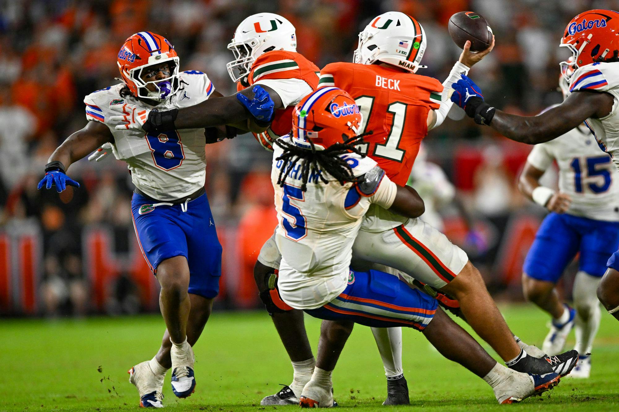 Miami Hurricanes quarterback Carson Beck (11) gets sacked by Florida Gators inside linebacker Myles Graham (5) during a football game between the Miami Hurricanes and the Florida Gators on Sept. 20, 2025, at Hard Rock Stadium in Miami Gardens, Fla.