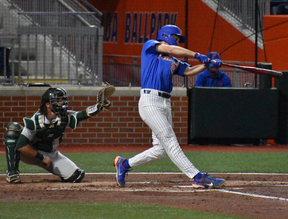 <p>Florida&#x27;s Sterlin Thompson swings against Jacksonville on March 13, 2021. Thompson hit a solo home run on Tuesday against the North Florida Ospreys en route to a 11-2 victory.</p>