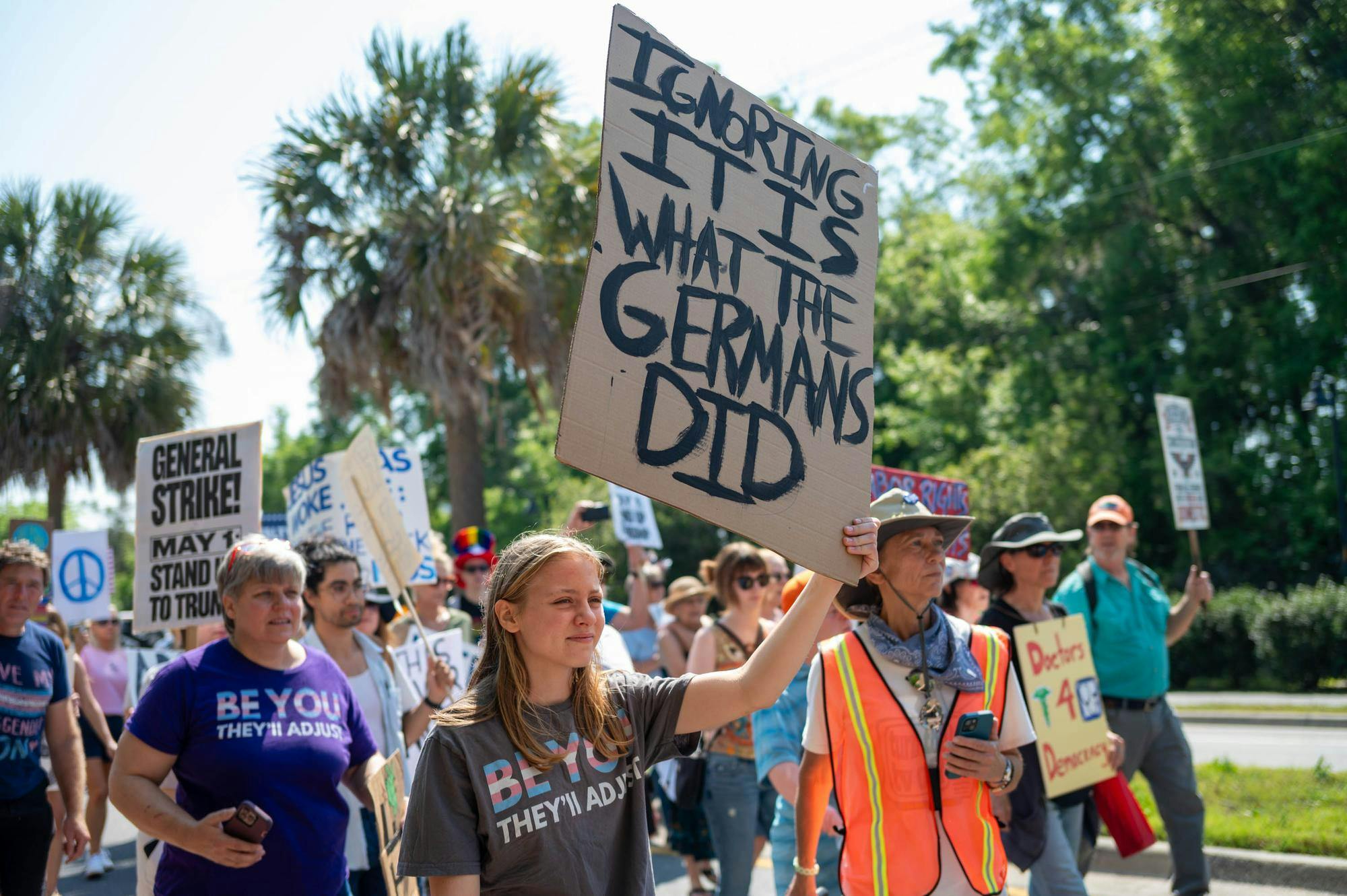 Protestors march down Depot Avenue, Saturday, March 28, 2026, in Gainesville, Fla.