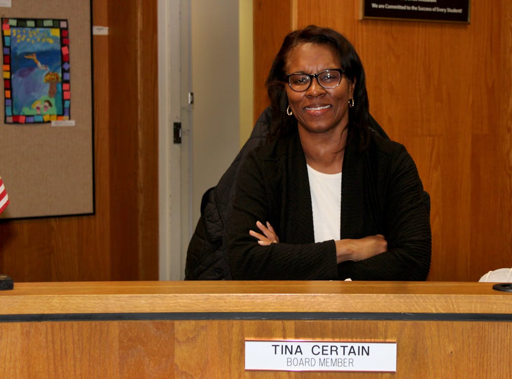 Tina Certain, Alachua County School Board member, poses for a portrait at her podium at the Alachua County School District on Wednesday, Feb. 15. Certain, who graduated from Gainesville High School and the University of Florida with an accounting degree, is one of two African American women who serve on the School Board. “If you’ve seen someone who’s done it, it sparks in your mind that you can do it,” Certain said. 