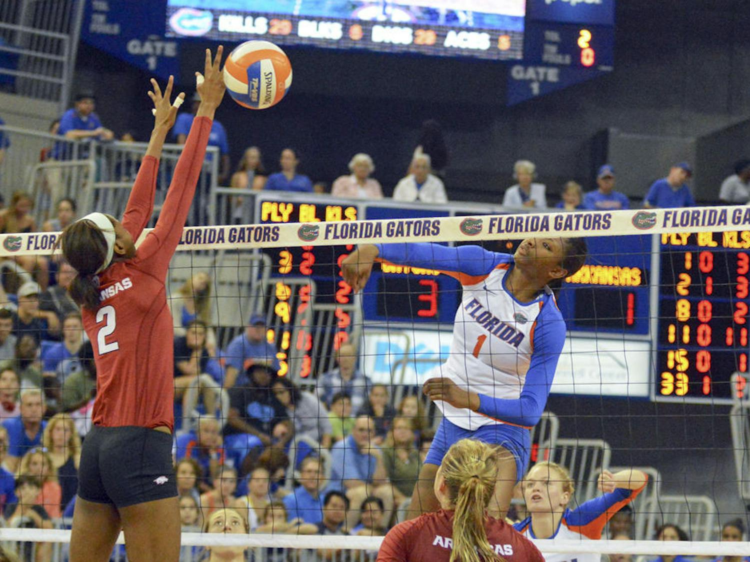 Rhamat Alhassan (1) swings for a kill attempt during Florida's 3-0 win against Arkansas on Sunday in the O'Connell Center.