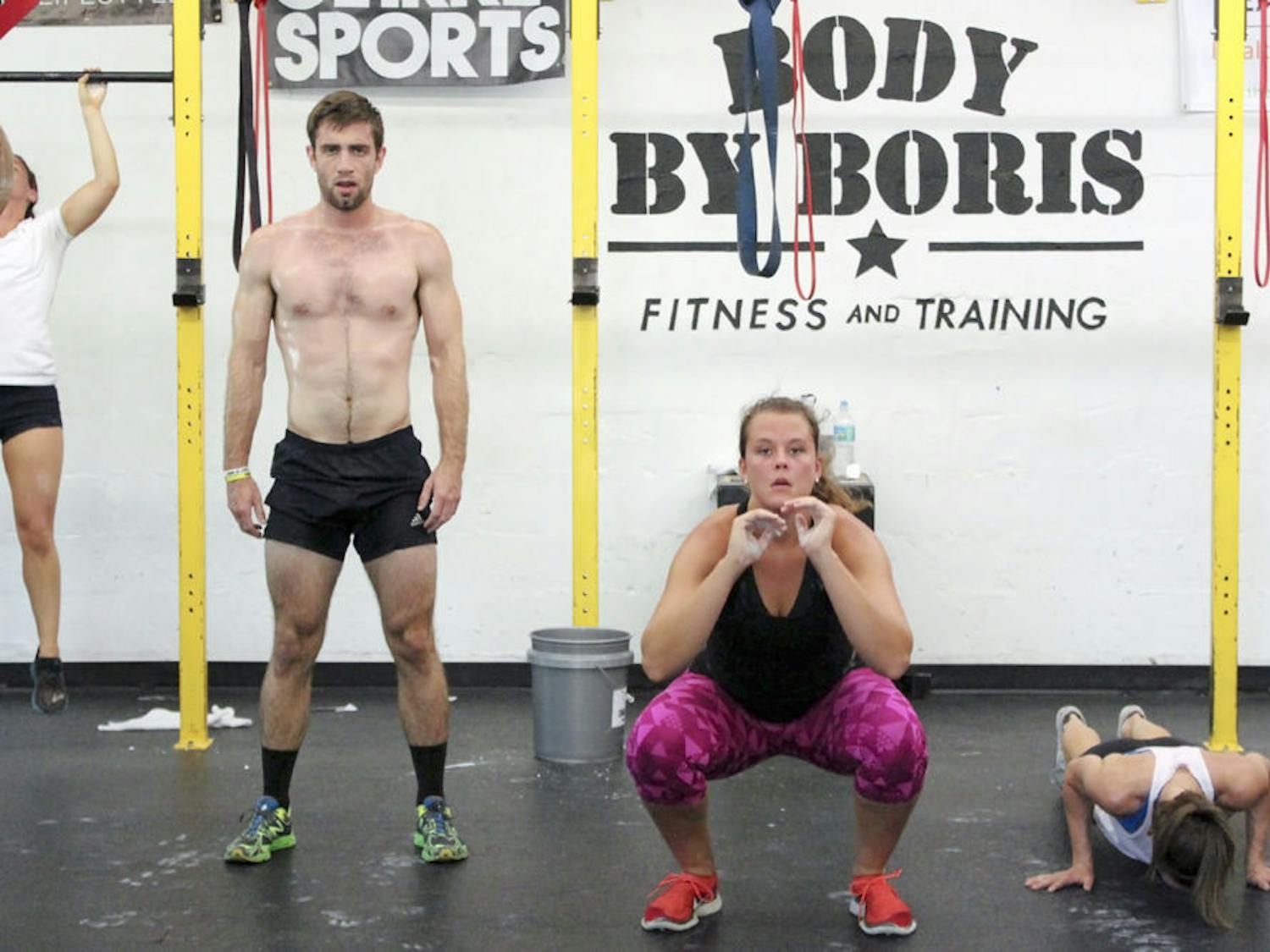 From left: Hunter Wyatt, 24, Samantha Mauder, 22, and Chloe Herring, 23, perform various exercises at the Memorial Day Murph event put on by Body By Boris, 1527 NW 6th St., on Monday. The event benefitted the Jonathan Cote Memorial Scholarships, which helps veteran UF and Santa Fe students pay for books and tuition.