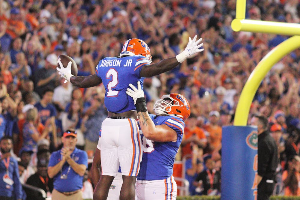Running back Montrell Johnson Jr. is lifted up in celebration by offensive lineman Austin Barber after a Florida touchdown against LSU Saturday, Oct. 15, 2022. 