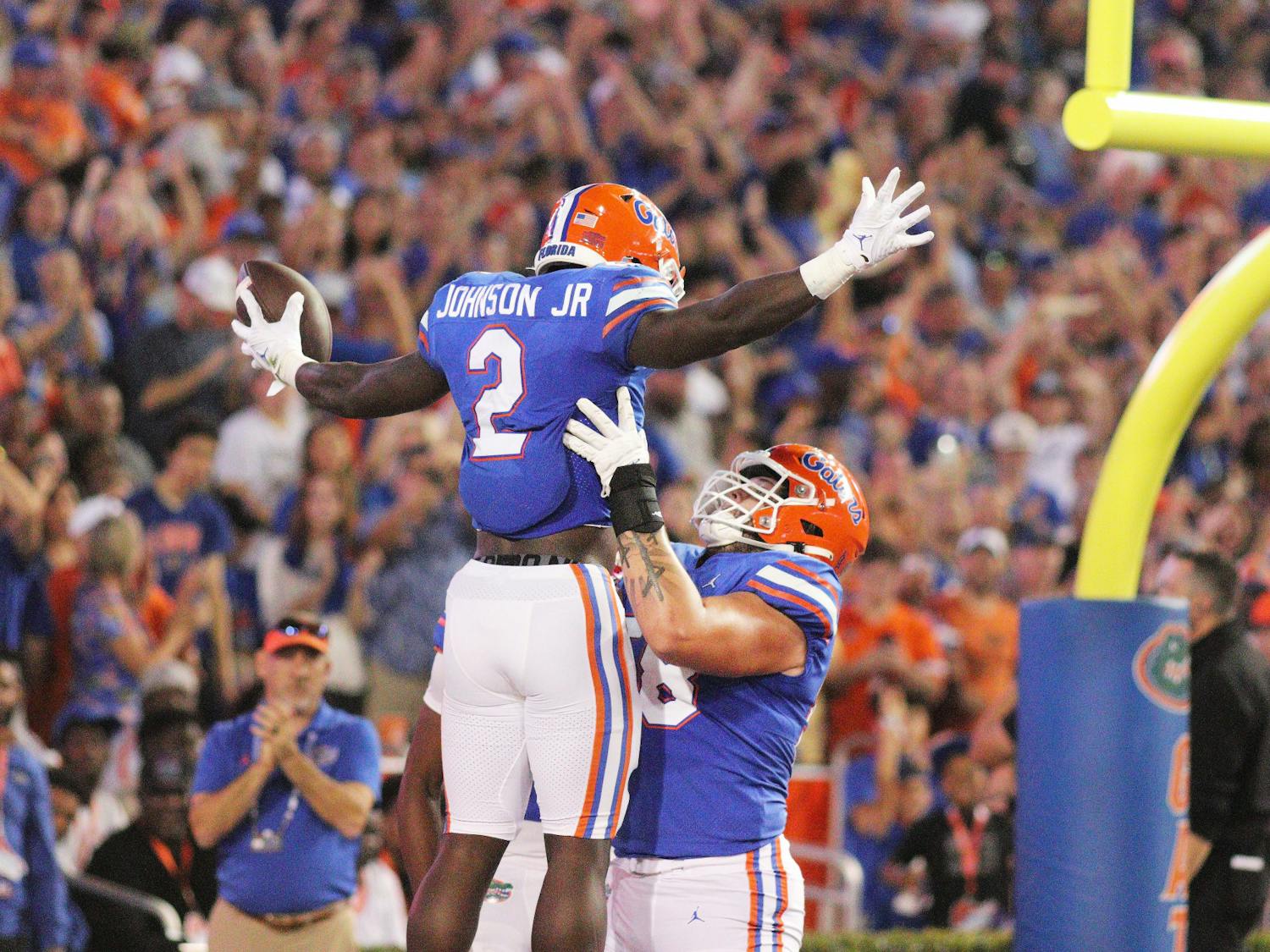 Running back Montrell Johnson Jr. is lifted up in celebration by offensive lineman Austin Barber after a Florida touchdown against LSU Saturday, Oct. 15, 2022. 