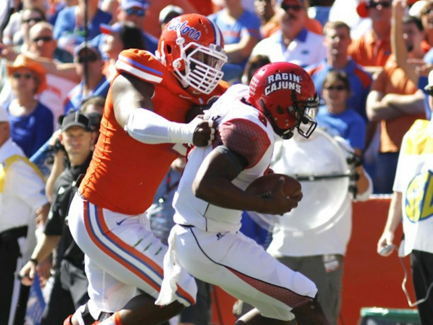 Defensive lineman Dominique Easley tackles Louisiana quarterback Terrence Broadway during Florida's 27-20 win on Nov. 10 in Ben Hill Griffin Stadium. Easley returned to practice Tuesday after missing Monday with the flu.