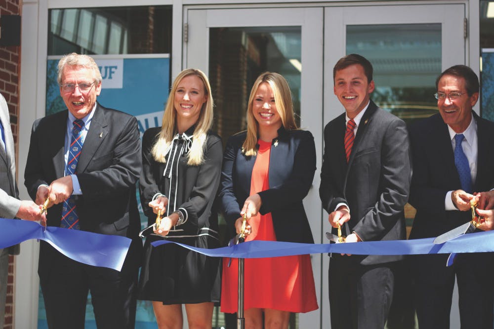David W. Parrott, Christina Bonarrigo Villamil, Susan Webster, Blake Murphy and Charlie Lane (not pictured: Bernard Machen and Joseph Glover) are pictured cutting the ribbon for the Newell Hall Grand Opening Ceremony on Monday morning.