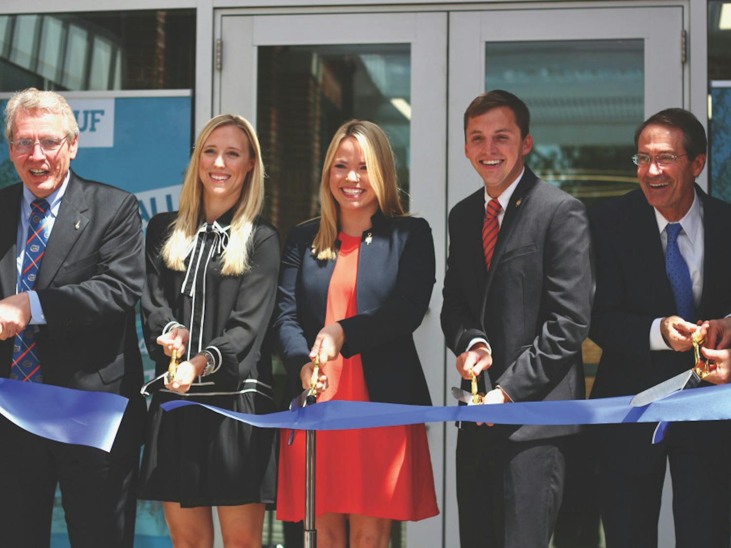 David W. Parrott, Christina Bonarrigo Villamil, Susan Webster, Blake Murphy and Charlie Lane (not pictured: Bernard Machen and Joseph Glover) are pictured cutting the ribbon for the Newell Hall Grand Opening Ceremony on Monday morning.