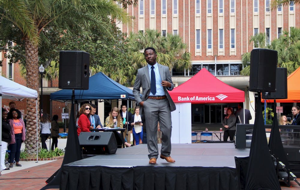 Kevin Arneus, a 21-year-old senior psychology major, models some of the available clothes at the Gator Career Closet Expo event on the Plaza of the Americas on Wednesday morning. 
