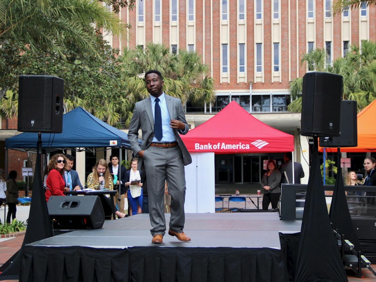 Kevin Arneus, a 21-year-old senior psychology major, models some of the available clothes at the Gator Career Closet Expo event on the Plaza of the Americas on Wednesday morning.