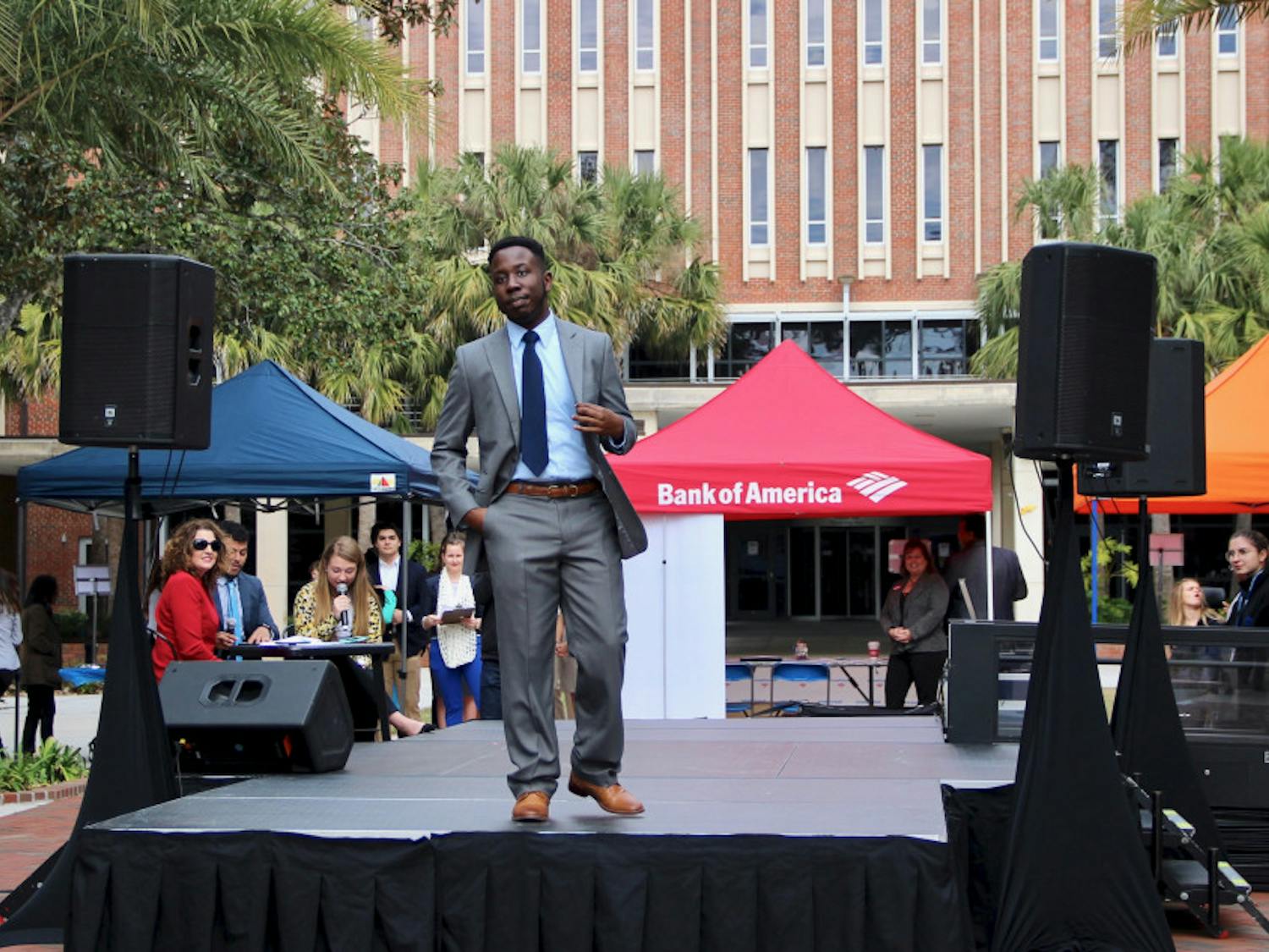 Kevin Arneus, a 21-year-old senior psychology major, models some of the available clothes at the Gator Career Closet Expo event on the Plaza of the Americas on Wednesday morning. 